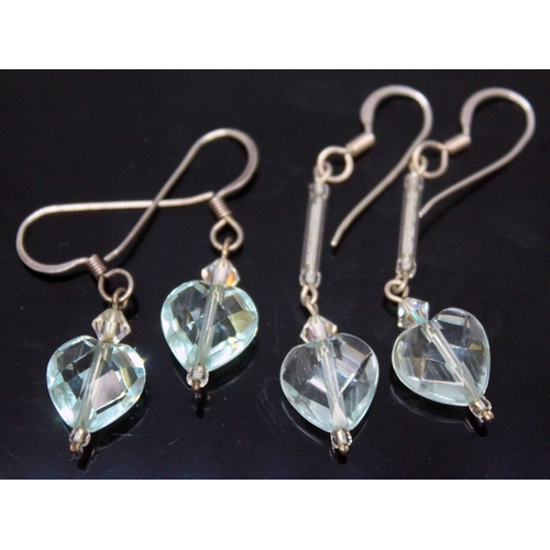 171 - Two pairs of aquamarine earings, each formed as a facetted heart shaped cut stone on drop, lengths 2... 