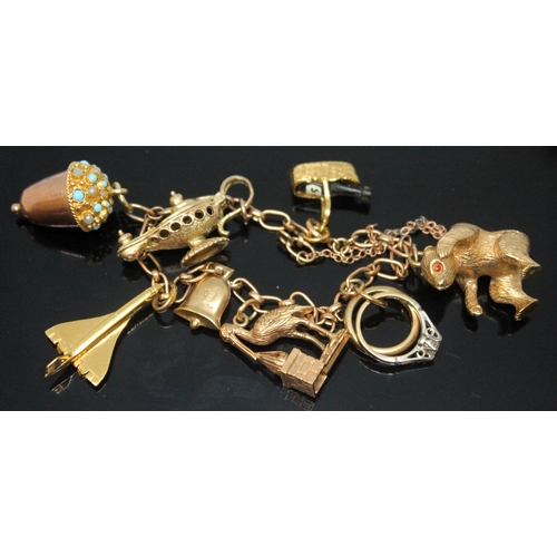 175 - A hallmarked 9ct gold charm bracelet featuring eight charms, gross wt. 28.75g, length 14cm.