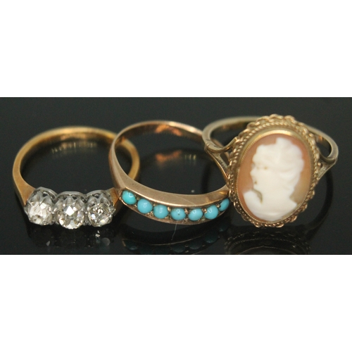 177 - A group of three rings comprising a three stone diamond ring marked '18ct', a ring set with turquois... 