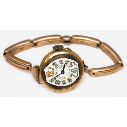 187 - A ladies Art Deco style wristwatch with stylised numerals, marked '14k' and strap marked '9ct', gros... 