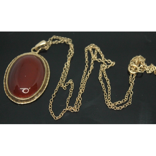 205 - A hallmarked 9ct gold mounted carnelian cabochon pendant, length 36mm, on hallmarked 9ct gold chain,... 