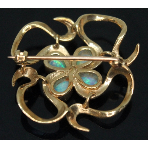 226 - A modern Arts & Crafts style hallmarked 9ct gold brooch set with four pear shaped precious opal cabo... 