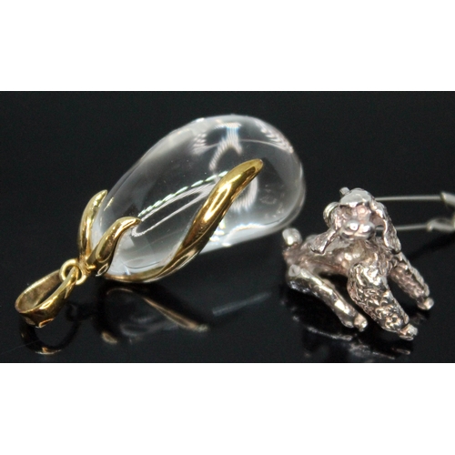 249 - A quartz rock crystal pendant mounted in 9ct gold gold, together with a silver poodle charm.