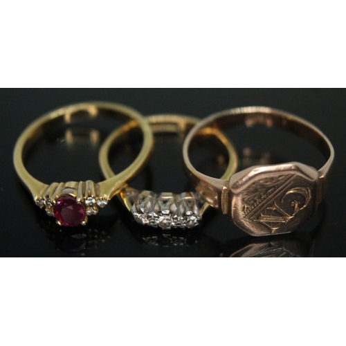 252 - A group of three rings comprising a hallmarked 18ct gold diamond and glass filled ruby cluster, a th... 