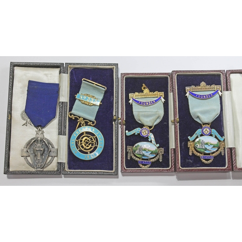 261 - A group of four hallmarked silver Masonic type medals, three boxed.