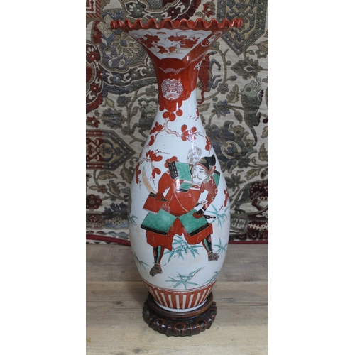 452 - A large Japanese porcelain vase with crimped and flared rim, carved wooden stand, height 69cm.