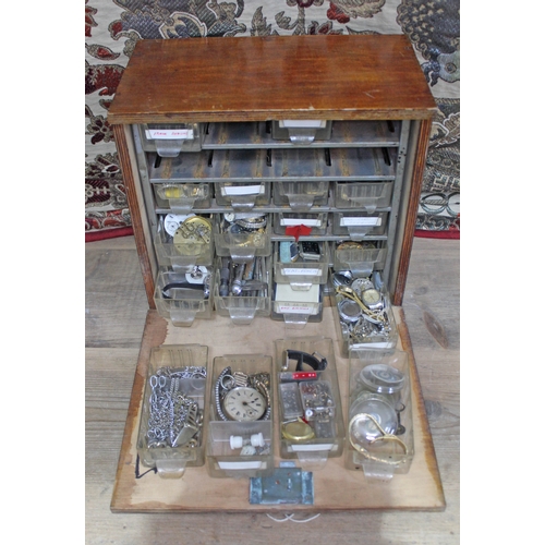 457 - A wooden cabinet of watch spares and repairs.