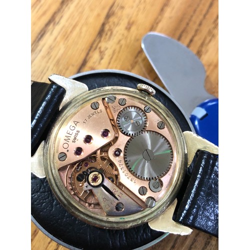 118 - A 1952 gold plated Omega wristwatch with gold tone signed dial, alternate Roman numerals and hour ba... 