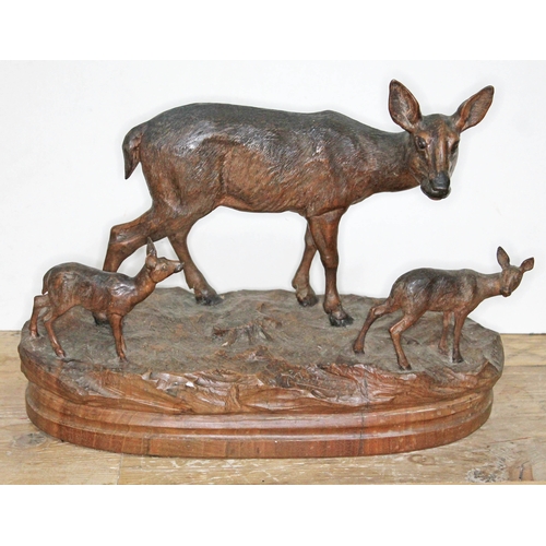 316 - A finely carved Black Forest wood sculpture depicting three deer on naturalistically formed base, in... 