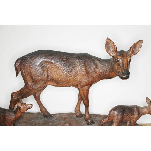 316 - A finely carved Black Forest wood sculpture depicting three deer on naturalistically formed base, in... 