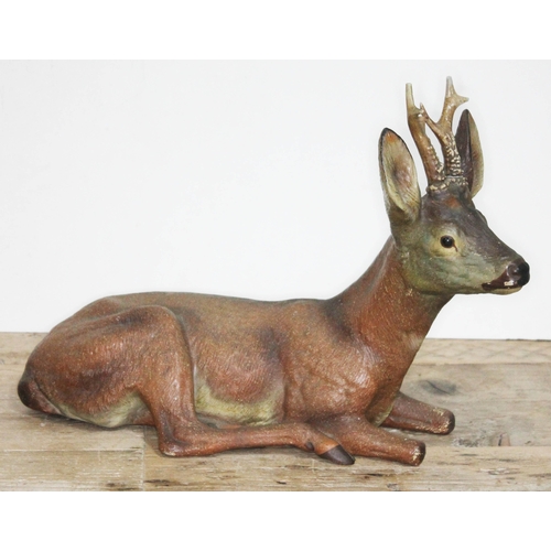 317 - A large terracotta figure depicting a seated deer, length 43cm.