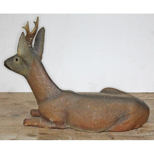 317 - A large terracotta figure depicting a seated deer, length 43cm.