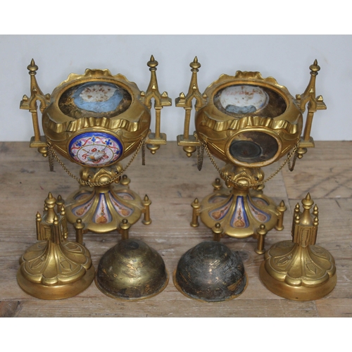 320 - A pair of ormolu and porcelain urns, architectural style with finials, handles and bows, each with a... 