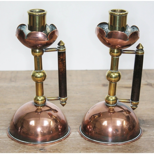 329 - A pair of Arts & Crafts copper and brass candlesticks, manner of Christopher Dresser/Benham & Froud,... 