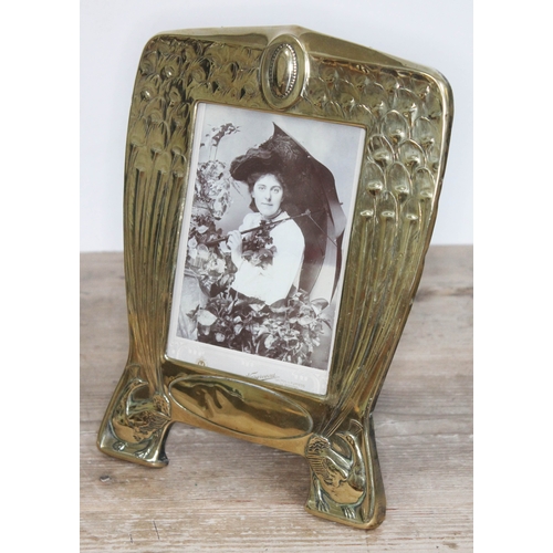 330 - An Edwardian brass photoframe designed with peacocks, height 25cm.