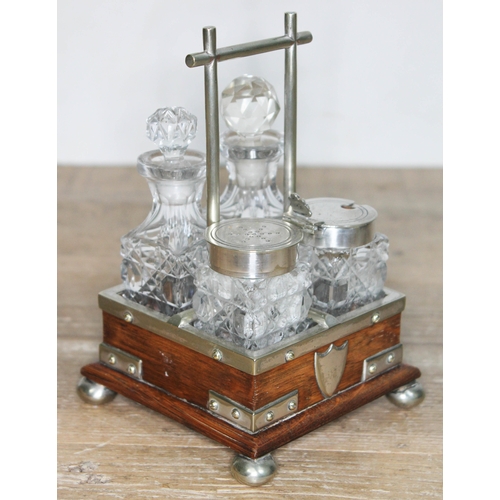 332 - A silver plated and oak cruet in the manner of Christopher Dresser, height 16cm.