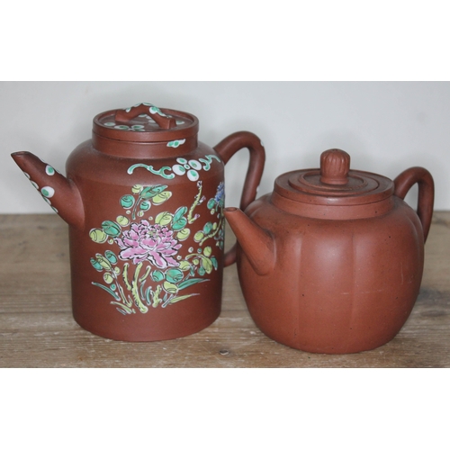 335 - Two Chinese yixing teapots, heights 12cm and 14cm.