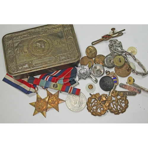 296 - A WWI Christmas tin and contents including three WWII medals, badges etc.