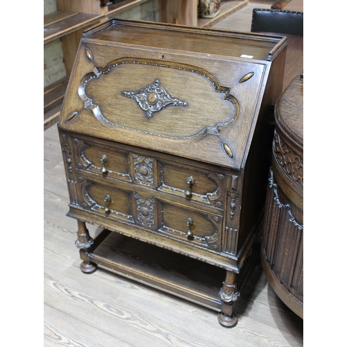 61 - A 1920s carved oak bureau, width 78cm, depth 45cm & height 107cm.