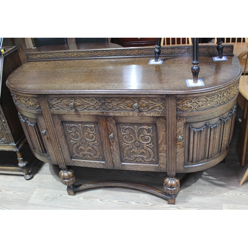 62 - A 1930s Jacobean style carved oak sideboard, length 165cm, depth 59cm & height 101cm.