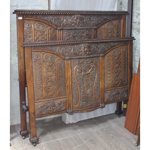 69 - A profusely carved mahogany double bedstead.