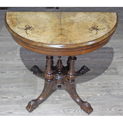 72 - A Victorian demi lune walnut fold over games table.