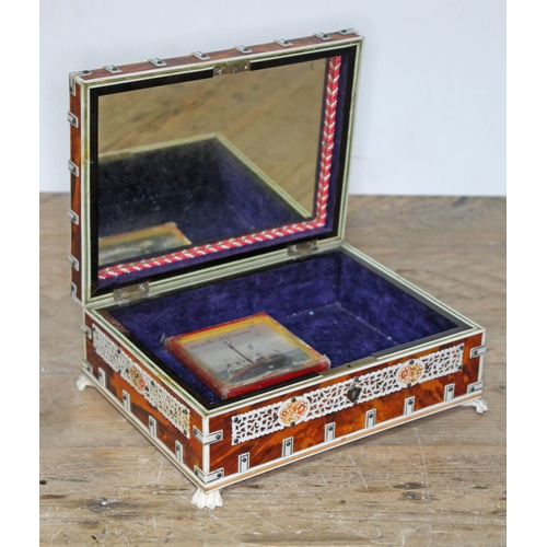 76 - A late 19th century Indian tortoiseshell and ivory box, length 21.5cm.