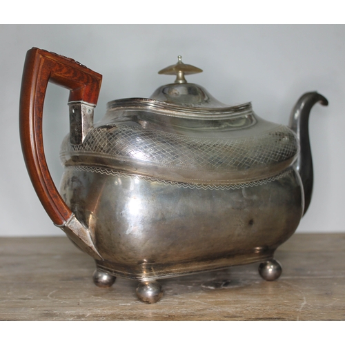 84 - A George III Irish silver teapot, with wooden handle, horn finial, engraved, ball feet, maker's init... 