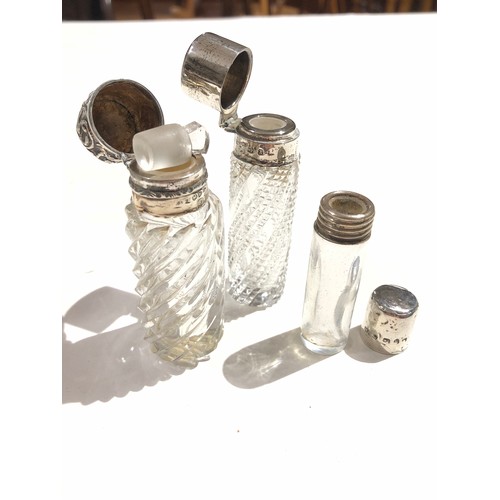 91 - A group of fourteen hallmarked silver topped or mounted glass bottles and jars, tallest 14cm.