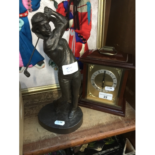 22 - A bronzed golfing figure and a mantle clock