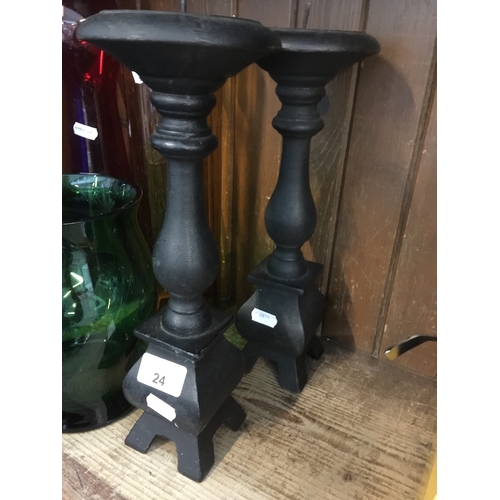 24 - A pair of cast iron candle sticks