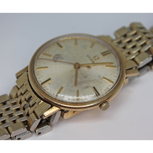 121 - A vintage gold plated Omega manual wind wristwatch with signed dial, gold hands and hour markers on ... 