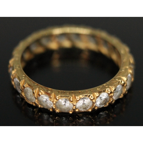 132 - An 18ct gold and colourless synthetic spinel eternity ring marked 18ct, UK size L, gross weight 2.8g... 