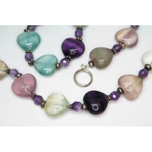 152 - A fluorite necklace and matching bracelet, each formed from heart shape cut green, purple, pink  and... 