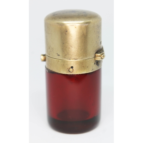 167 - A Victorian silver gilt mounted cranberry glass scent bottle, the interior lid with sprung glass sto... 