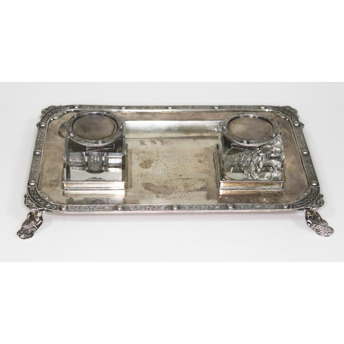 176 - A presentation silver inkstand, with two square glass inkwells on base with Celtic border and four m... 