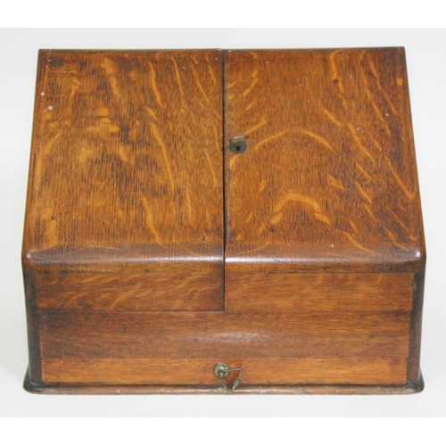 58 - An oak fold out stationary box with calendar, length 39cm.