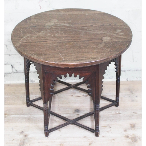 64 - A Moorish oak occasional table in the manner of Liberty & Co, round top above hexagonal section base... 