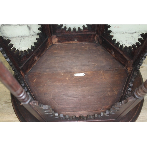 64 - A Moorish oak occasional table in the manner of Liberty & Co, round top above hexagonal section base... 