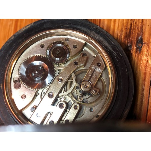 117 - A gun metal over sized pocket watch on oak watch stand, the watch having Roman numerals and seconds ... 