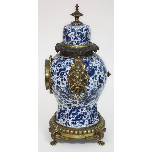 7 - A 19th century French faience blue and white and gilt metal mounted clock, with lion mask handles to... 