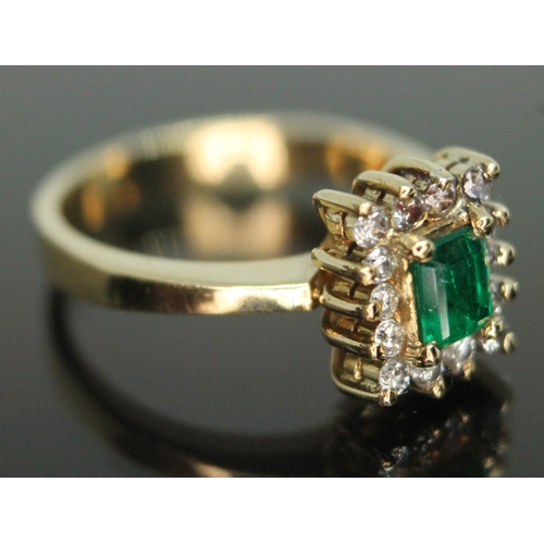 214 - A diamond and emerald cluster ring, marked 18k, the cluster measuring approx. 9mm x 8mm, gross wt. 5... 