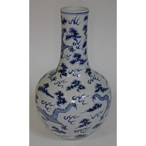 239 - A Chinese blue and white bottle vase decorated with dragons and clouds, four character mark to base,... 