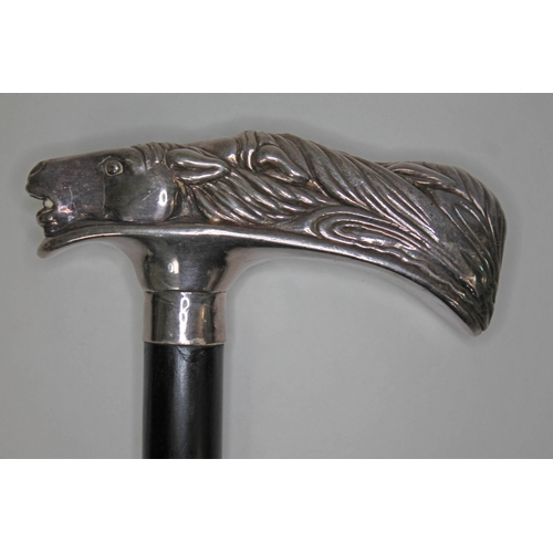 291 - A modern silver handled walking stick, the handle formed from horses heads, ebony cane, length 93cm,... 