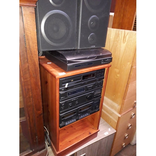 865 - A Sony hifi system and speakers in pine cabinet.