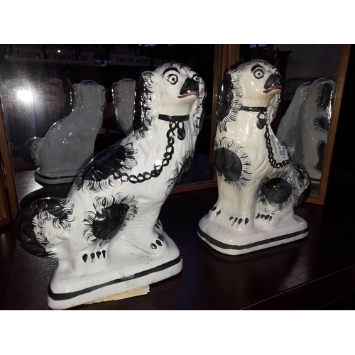 873 - A pair of 19th century Staffordshire pottery spaniels, height 29cm.