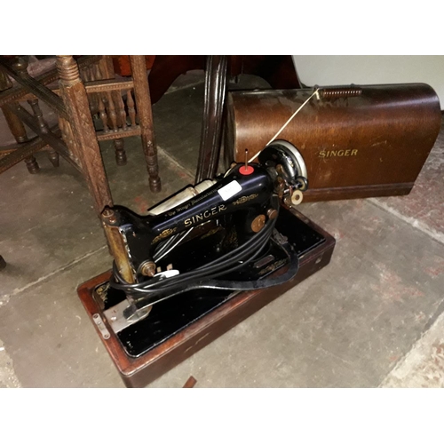 880 - A vintage cased Singer electric sewing machine - B.U.K 12E