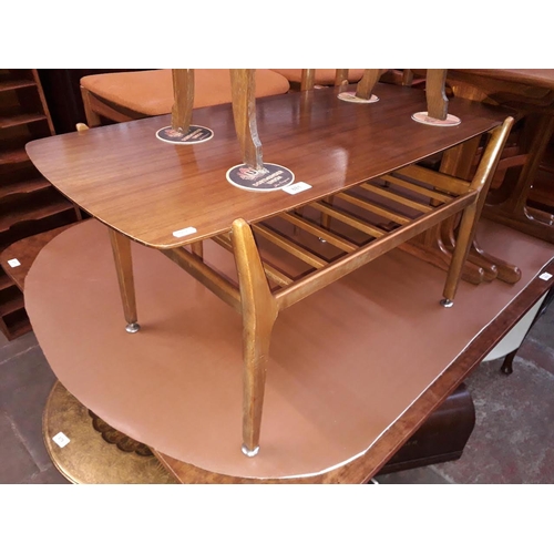 881 - A Nathan retro teak coffee table with lower tier rack, length 90cm.