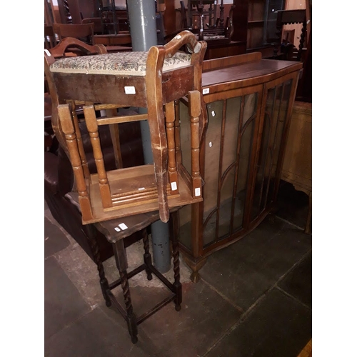 920 - An Art Deco walnut display cabinet, a piano stool, an occasional table and a 2/3 nest of tables.