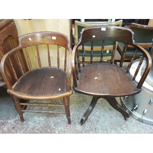 947 - Two spindle back oak captains chairs, one swivel